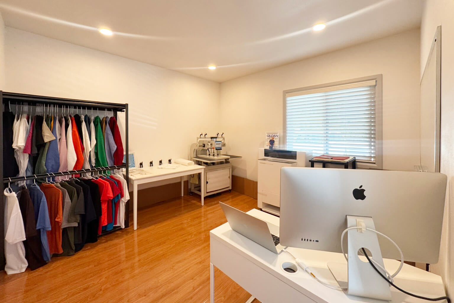 Creative 8 Apparels studio with a blank apparel rack and design desk