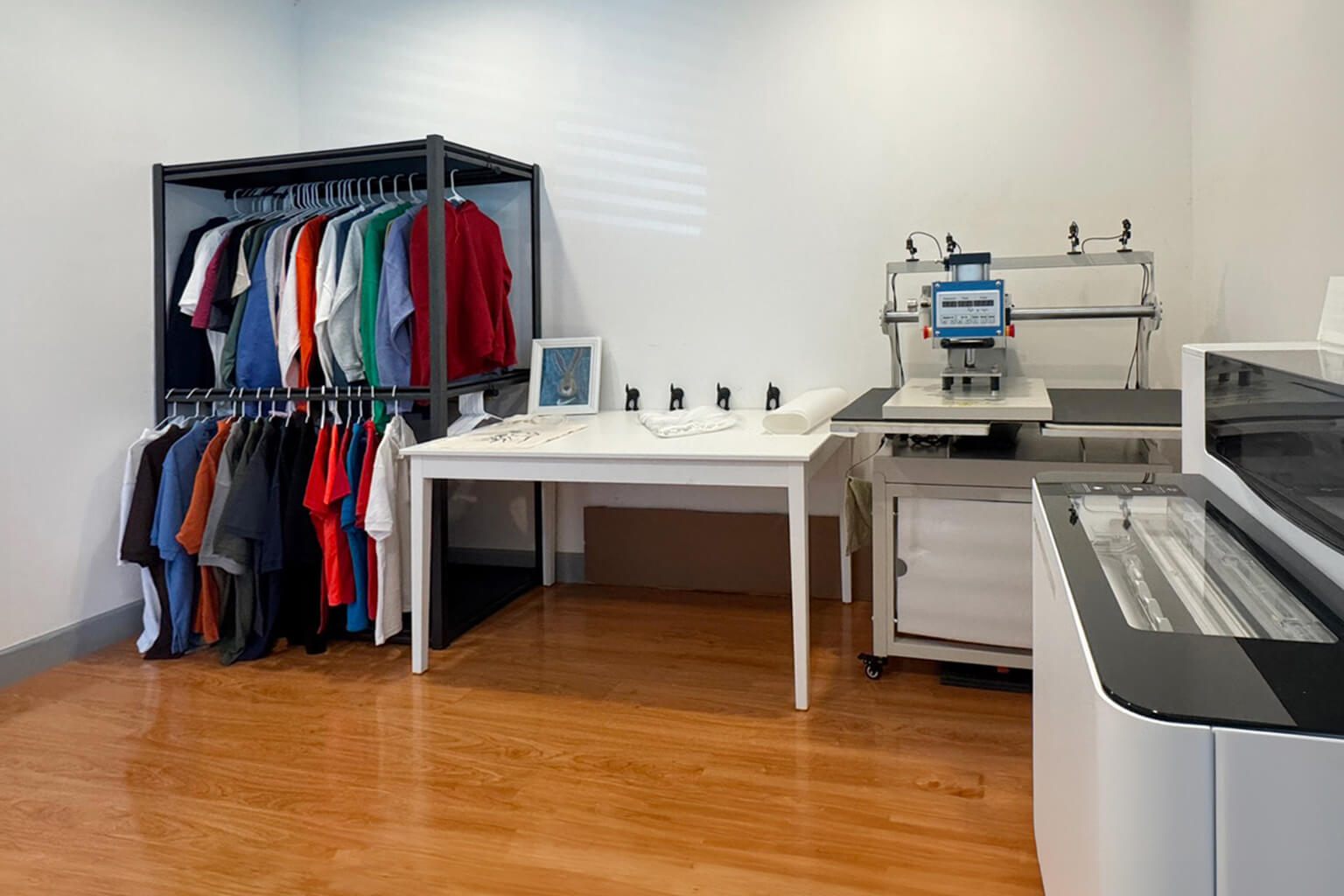 Heat press and blank garments in the Creative 8 Apparels studio